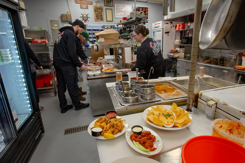 Staff in kitchen preparing food