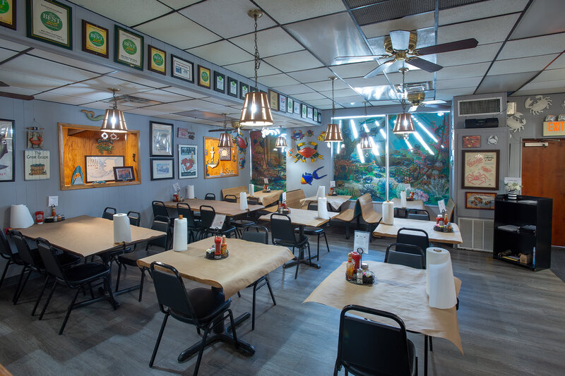 Main dining room with many set table and booth seatings