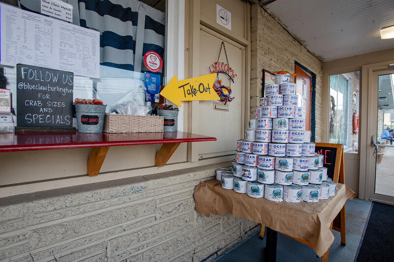 Take out window with cans of crab meat