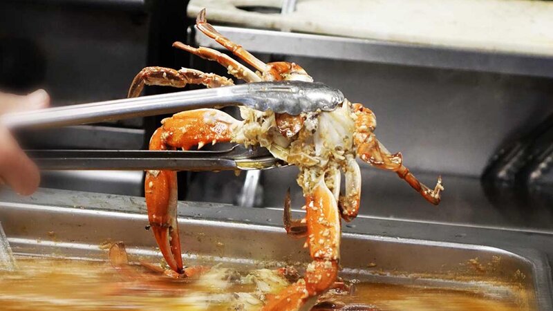 Crab being held above
