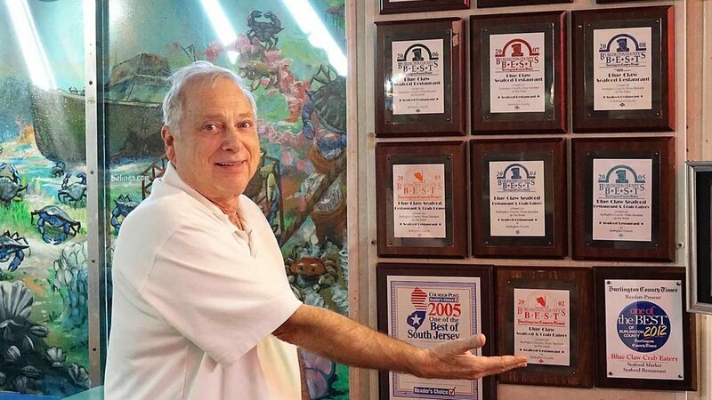 Norm showing all of the awards the Blue Claw has received