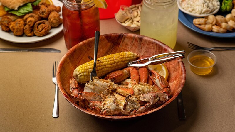 Crab pieces with side of corn on the cob in a bowl