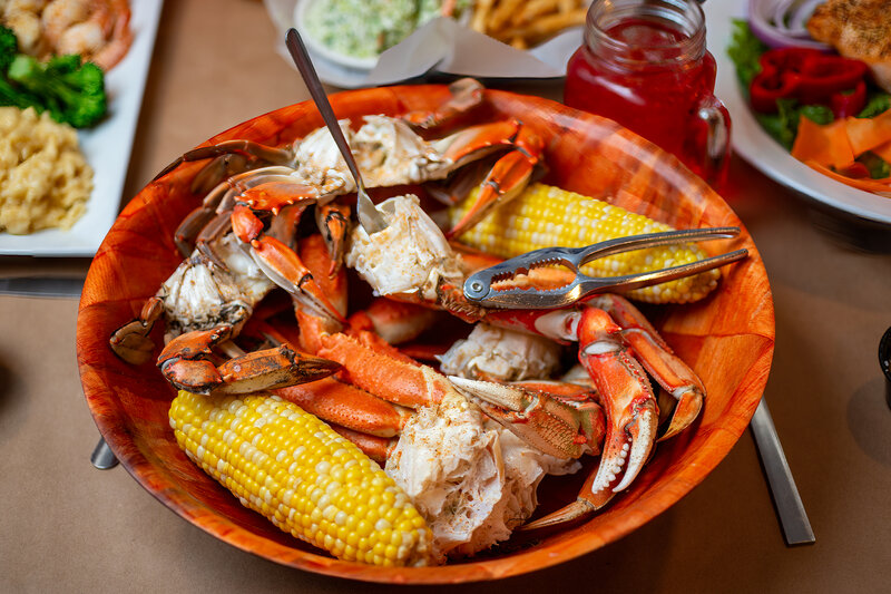 Crab legs and ears of corn in a bowl